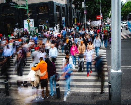 Crowded modern street in Mexico City during rush hour