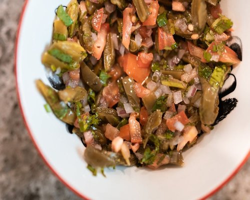 Healthy traditional Mexican meal with beans, nopales and fresh vegetables